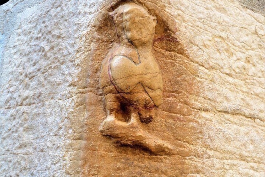A carved figure on a stone surface. 4