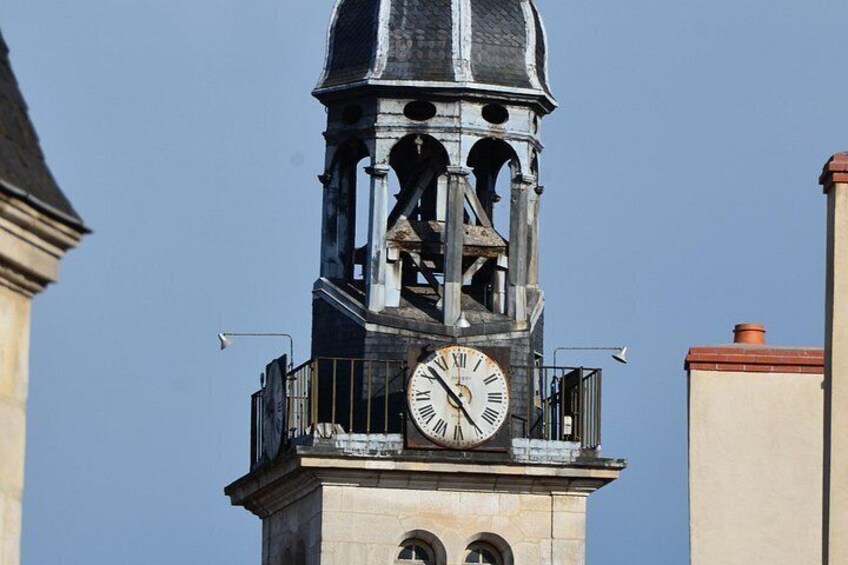 A clock tower with a dome and a balcony. 3