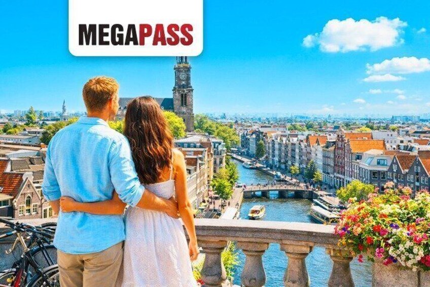 A couple overlooking a canal with historic buildings and a tower in the background. 1