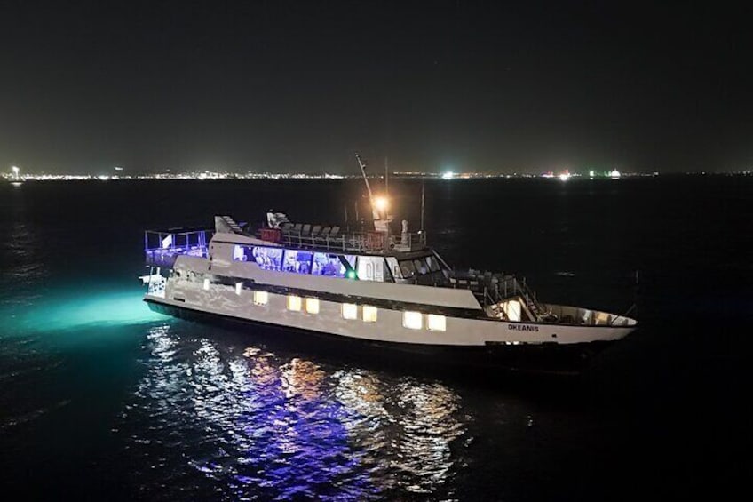 A large, illuminated boat named 'OKANAGAN' on calm waters at night. 1