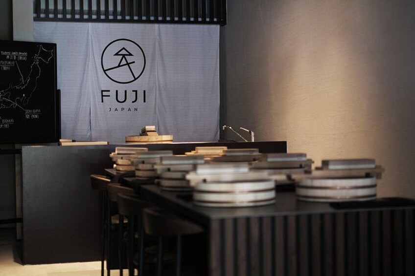 A FUJI branded display with a map and various items on a table. 3