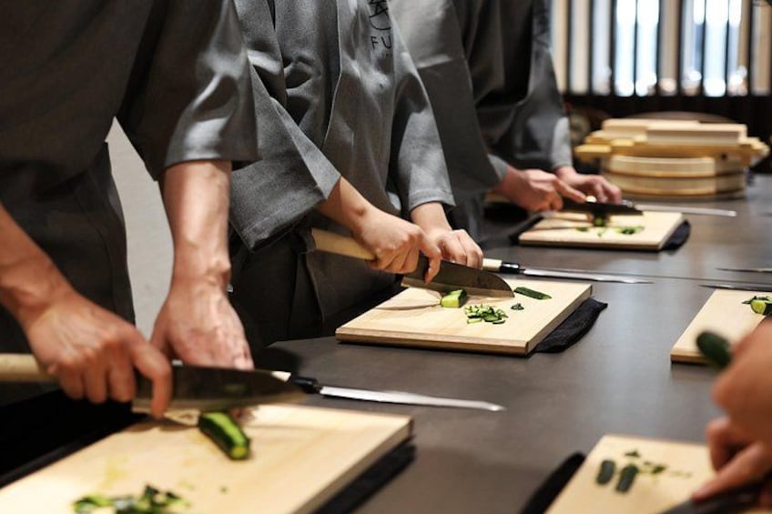 Chefs preparing food on wooden cutting boards. 1