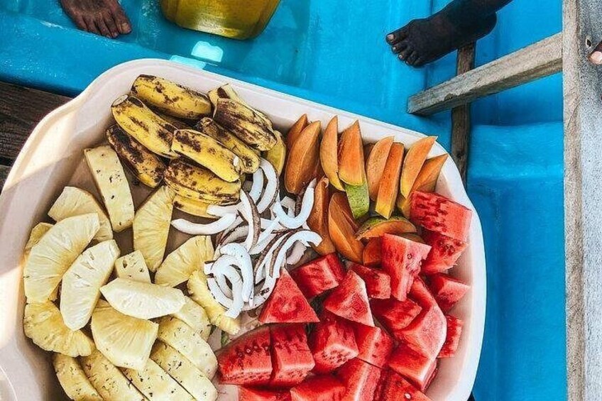 A tray of sliced fruits including bananas, pineapple, watermelon, and onions. 3
