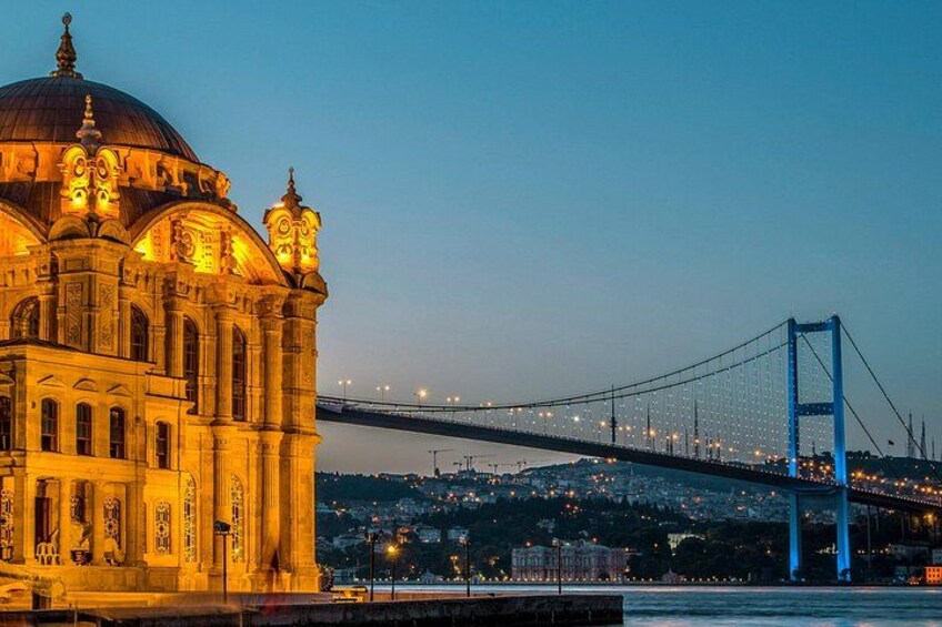 A historic building with ornate architecture and a large dome, a blue suspension bridge spanning a body of water, and a cityscape in the background. 3