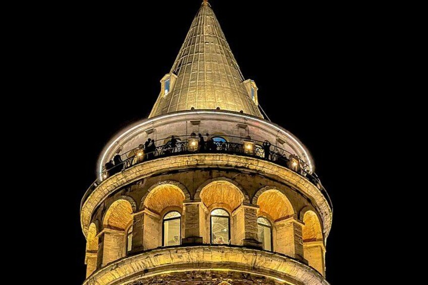 A lit dome structure with arched windows and a pointed roof. 2