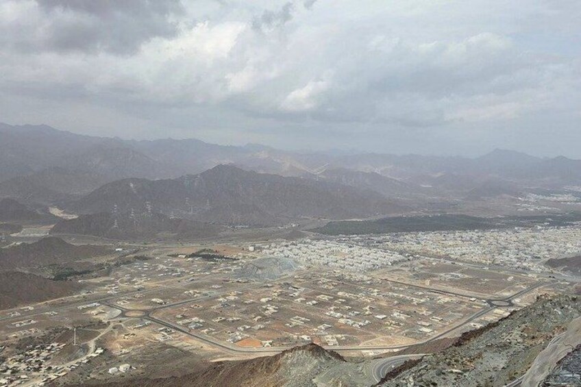 A mountainous landscape with a town and mining area. 1
