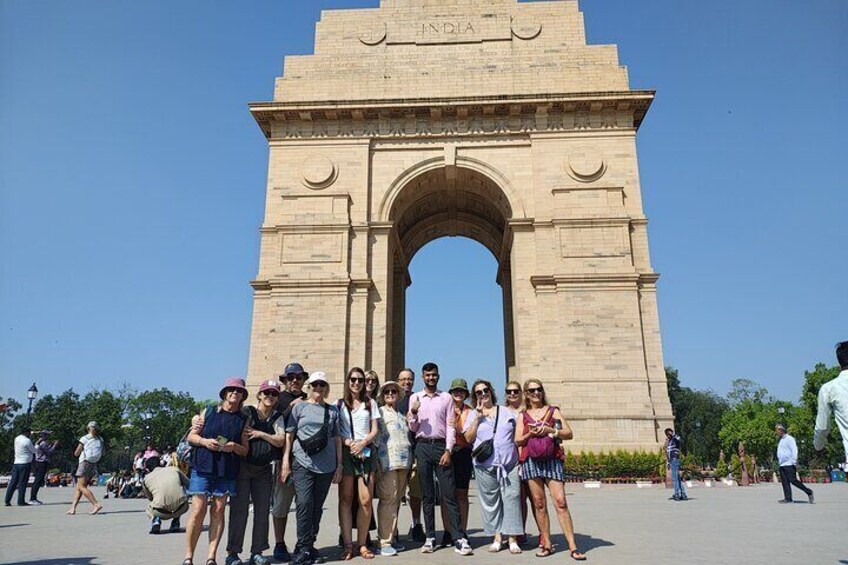 A group of people standing in front of the India Gate. 3
