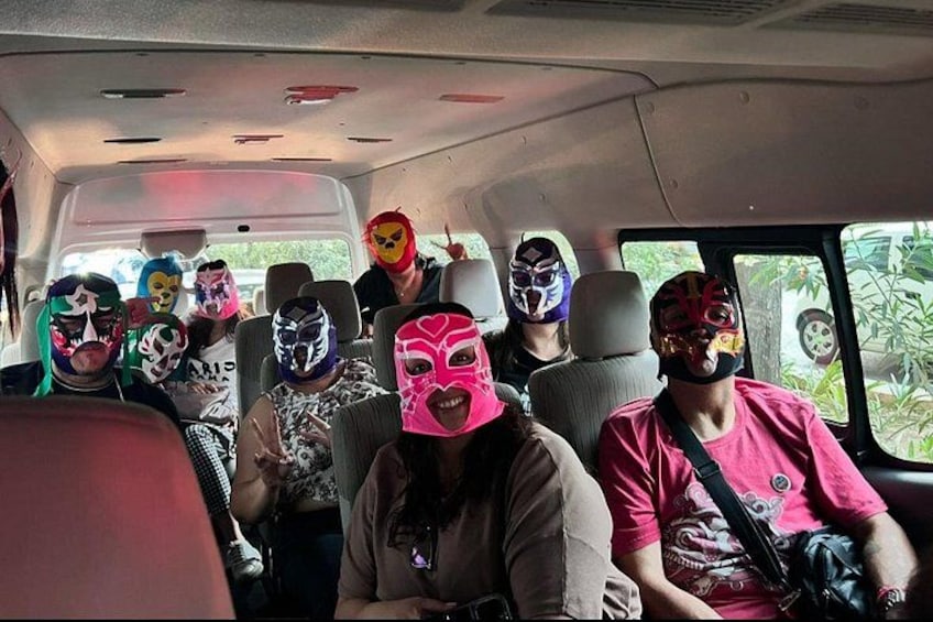 People in a vehicle wearing various masks. 1