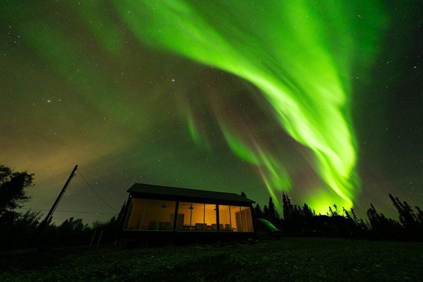 A house under a green aurora display. 2