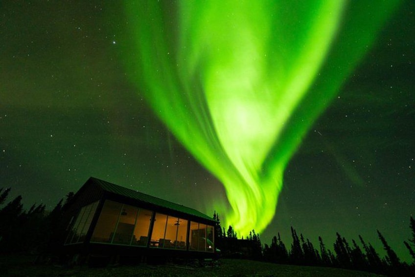 A house under a green aurora borealis. 4