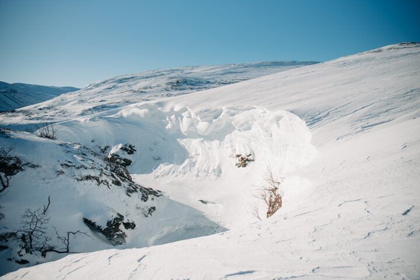 A snow-covered mountain landscape with a clear sky. 2