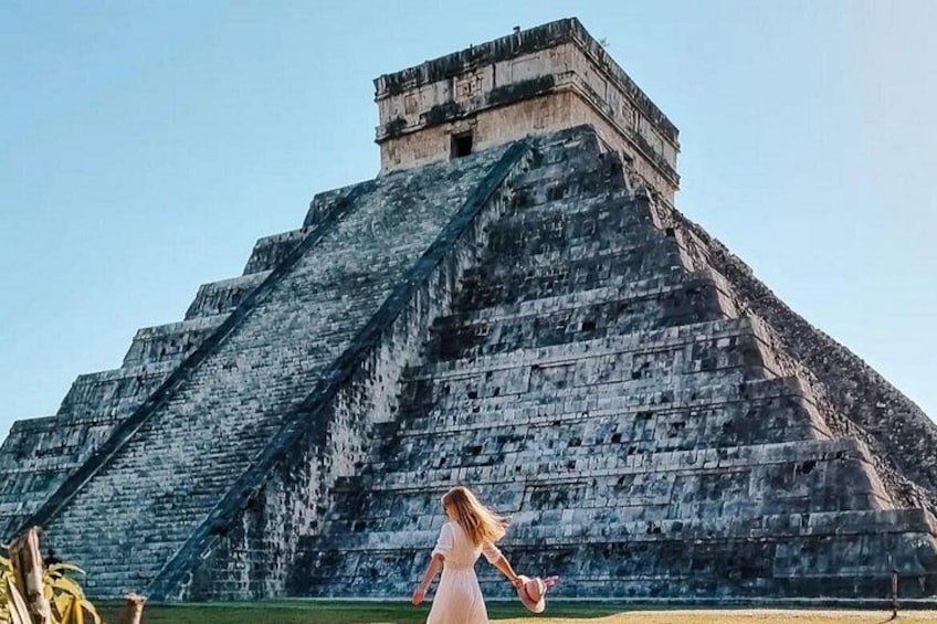 A large pyramid structure with a person in the foreground. 5