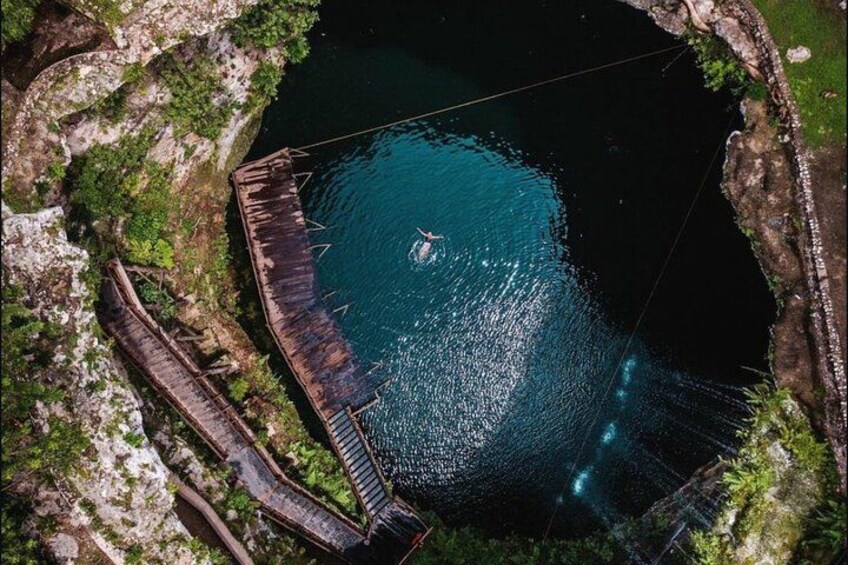 A large body of water surrounded by rocky terrain and a wooden structure. 3