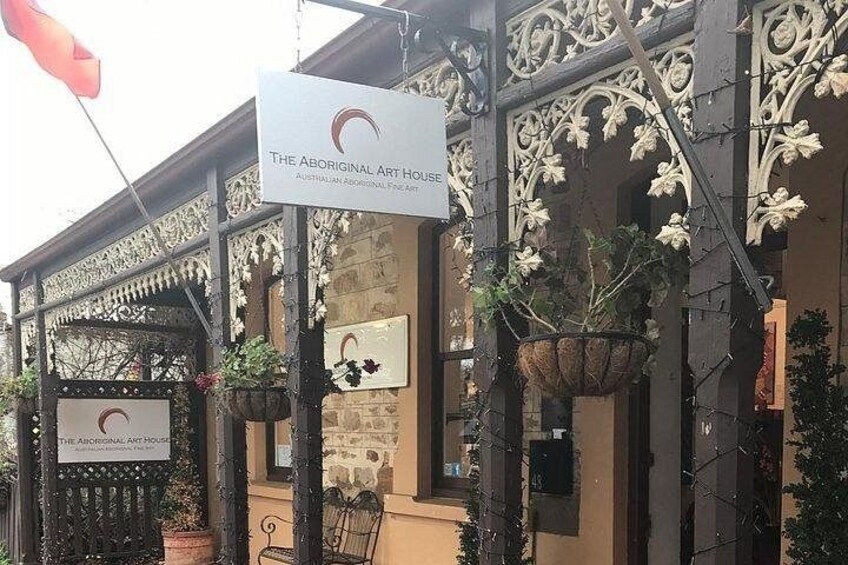 An ornate building with a sign reading 'The Aboriginal Art House.' 2