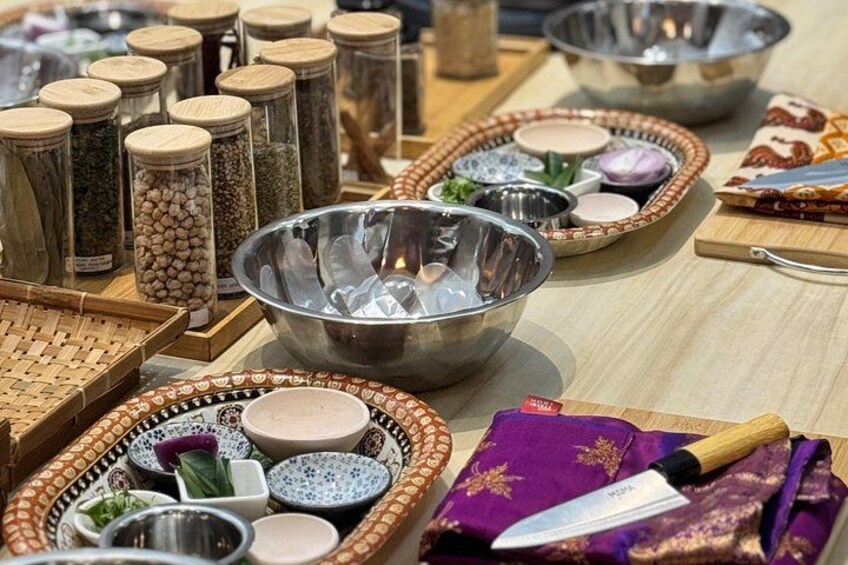A variety of kitchen utensils and containers, including bowls, jars, and a knife on a wooden table. 4