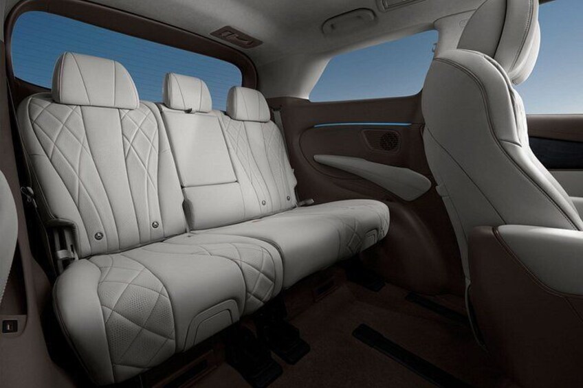 A car interior with leather seats and a sunroof. 4