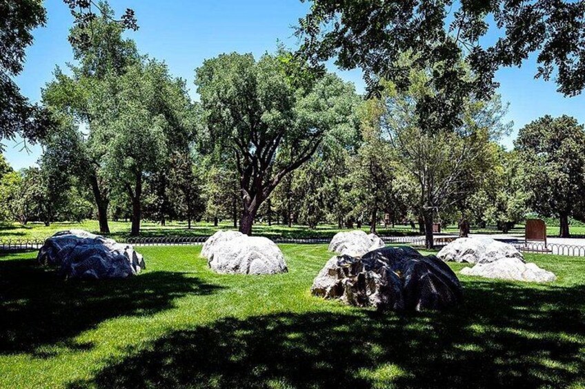 A park with large rocks and trees. 5