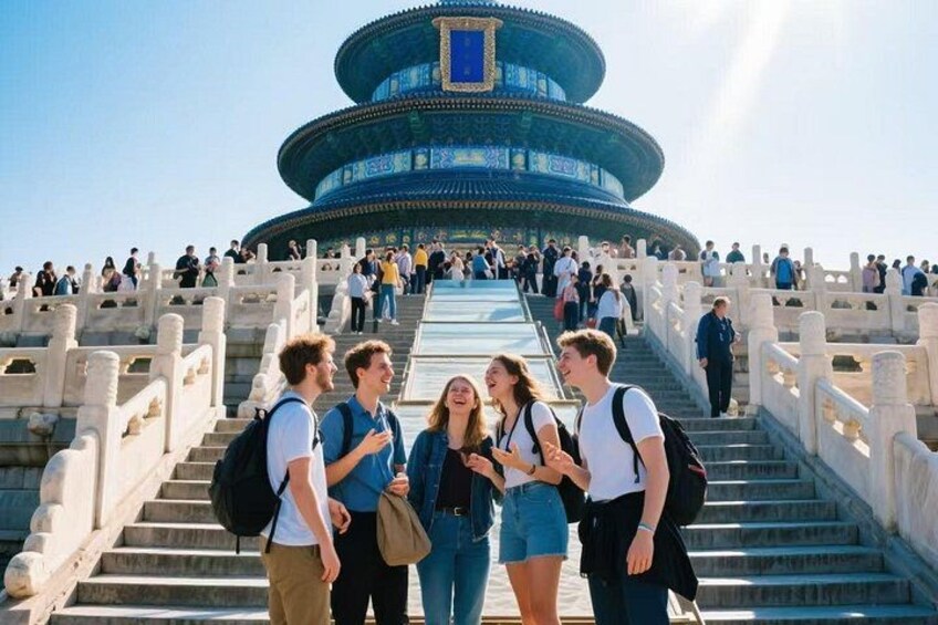 A group of people walking up a staircase towards a large, circular building with blue and gold decorations. 1