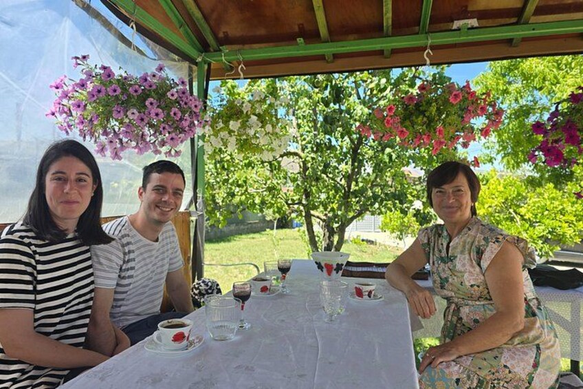 Three people sitting at a table with drinks and a glass of water. 2