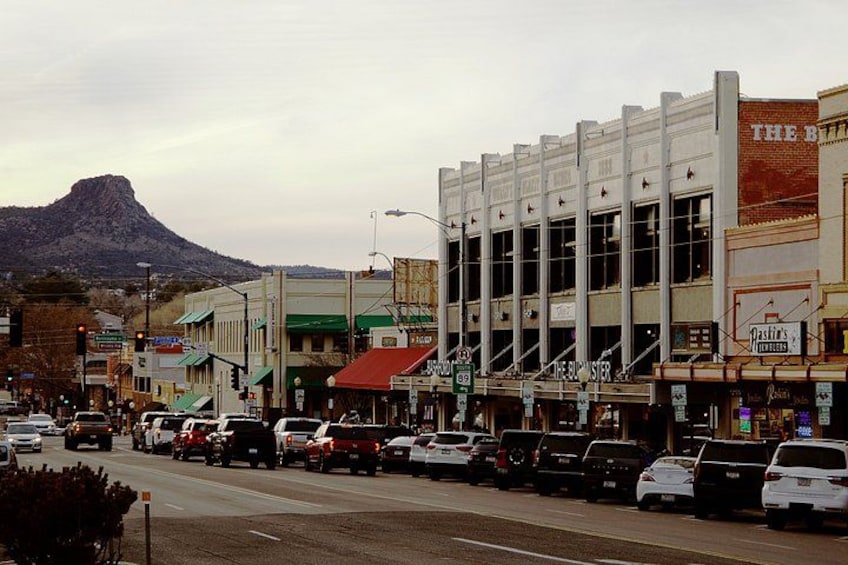 A street lined with buildings, including a theater and a bank. 4