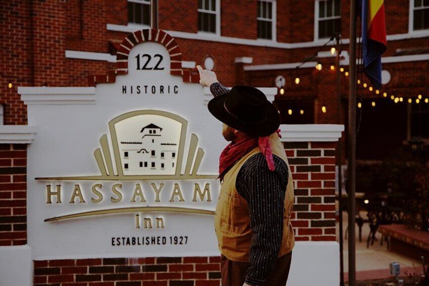 A historic building with a sign that reads 'Hassayamar Inn Established 1927' and the number '122' above it. 2