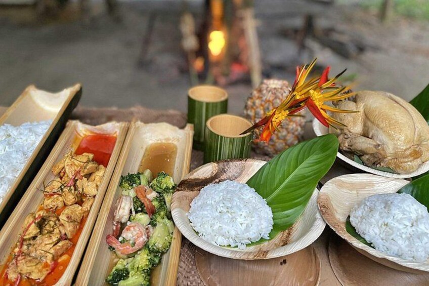 A variety of dishes including rice, chicken, and vegetables, arranged on a table with a decorative flower. 2