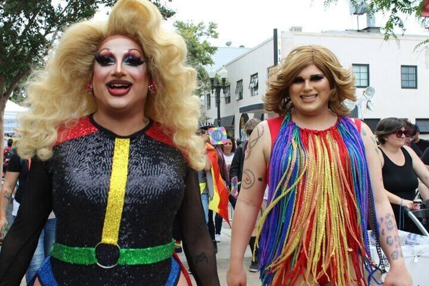 Two people in colorful outfits walking on a street. 5