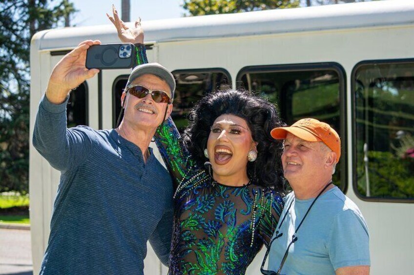 Three people taking a selfie with a bus in the background. 3