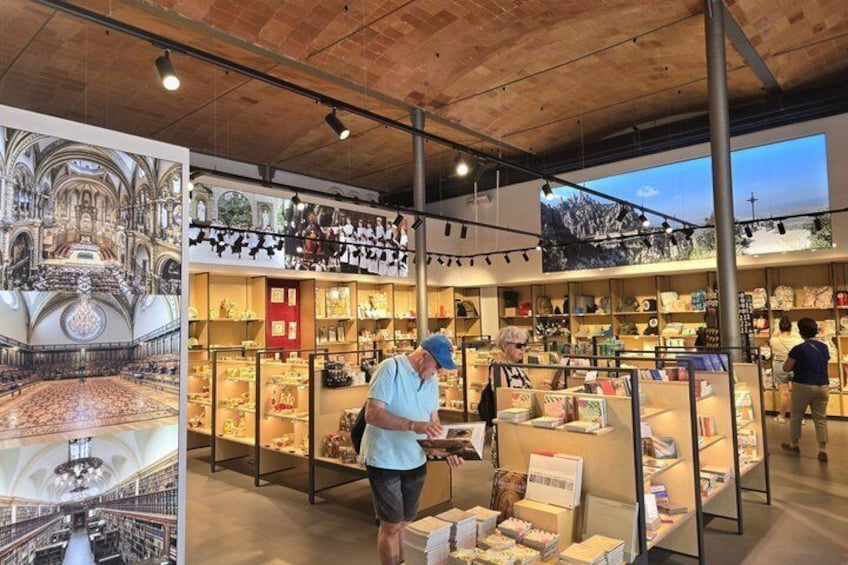 A bookstore with wooden ceilings and shelves filled with books and decorative items. 5