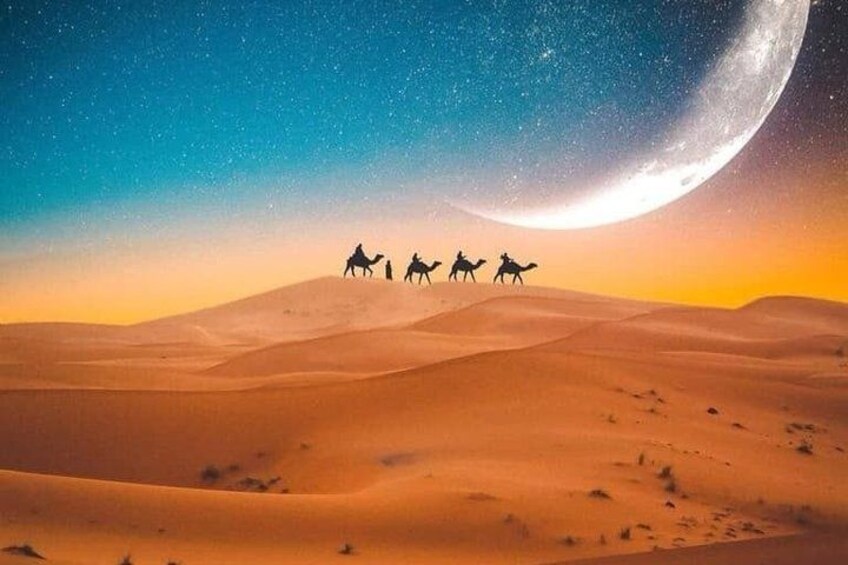 A desert landscape with sand dunes and a large moon in the sky. 2