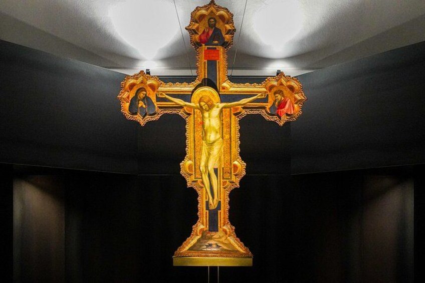 A crucifix with a figure of Jesus on the cross, surrounded by ornate decorations. 4