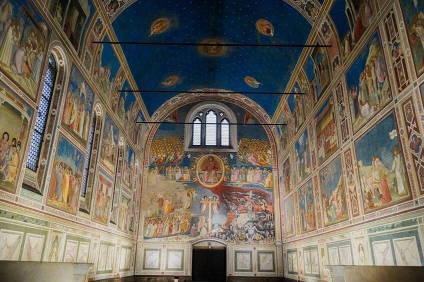 A church interior with frescoes, arched windows, and a central dome. 1