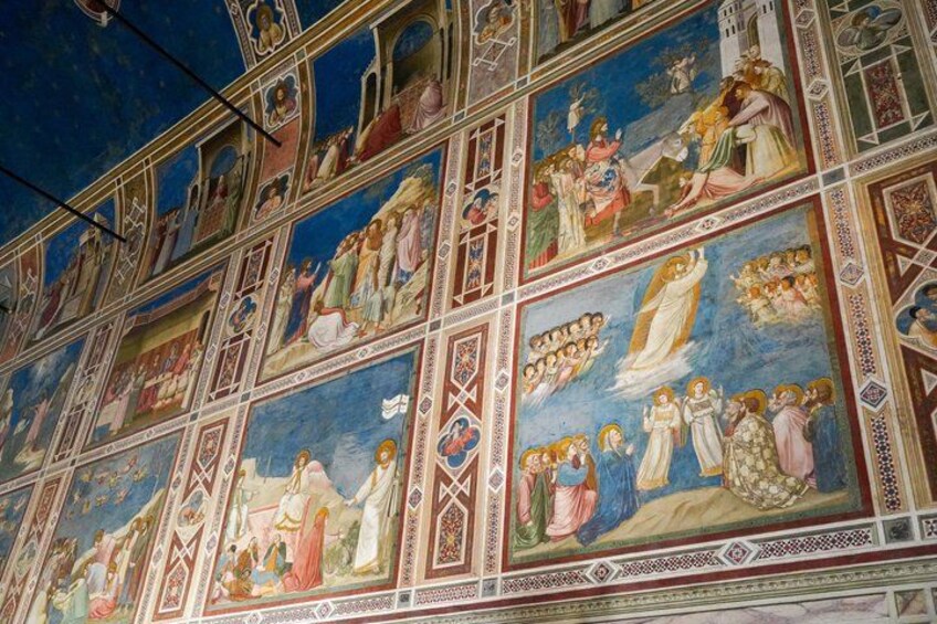 A detailed fresco mural with religious scenes, geometric patterns, and architectural elements. 2