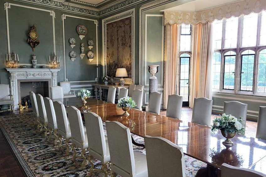 A formal meeting room with a long table, chairs, a fireplace, and decorative wall elements. 3