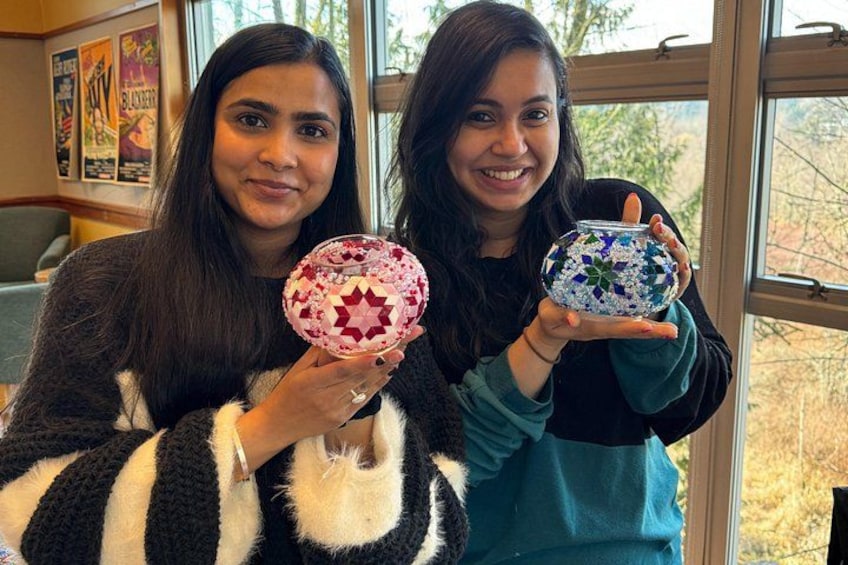 Two individuals holding decorative bowls. 3