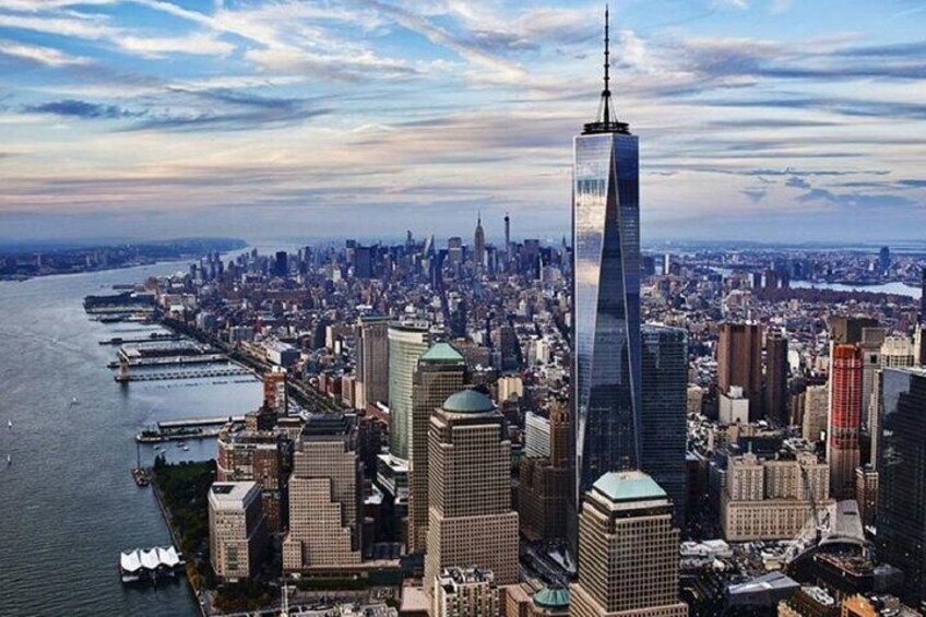 A cityscape with a prominent skyscraper, a river, and a bridge. 1