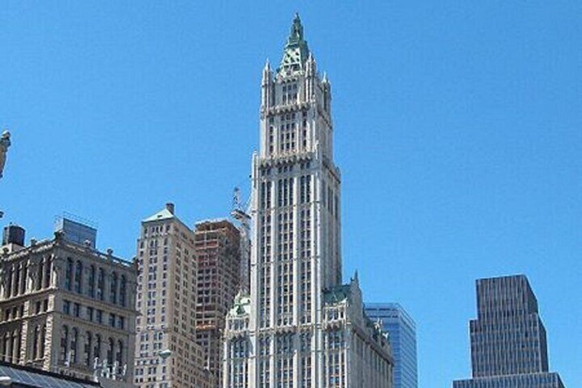 A city skyline with a prominent skyscraper featuring a clock tower. 2