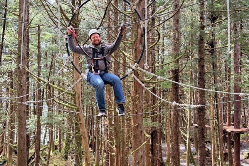 A person zip-lining through a forest. 2