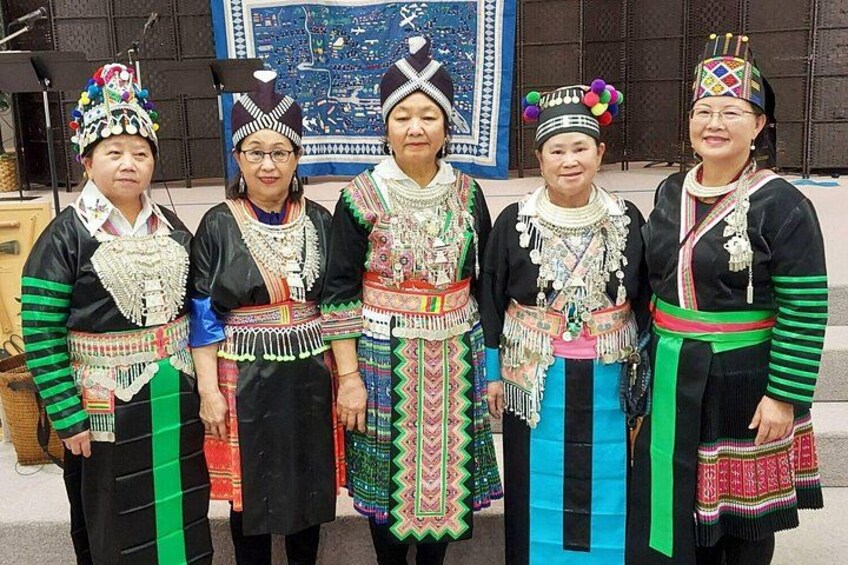 A group of people in traditional attire with elaborate headdresses and jewelry. 3