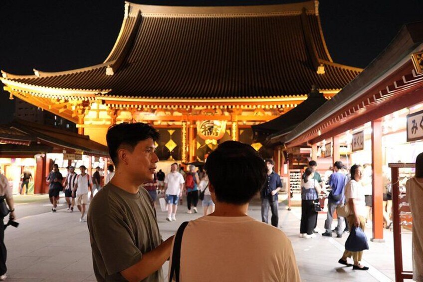 A traditional Asian architectural structure with a curved roof, illuminated by warm lighting. 4