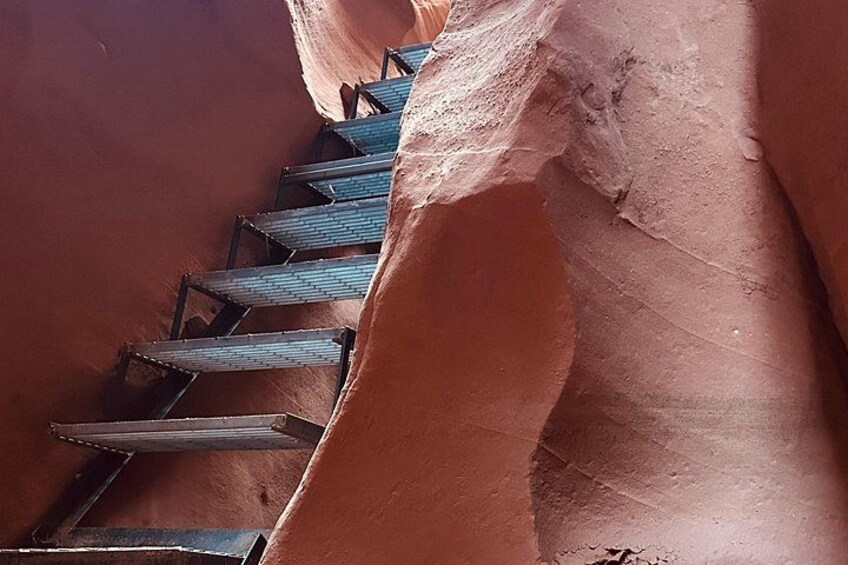 A staircase carved into a red rock wall. 2