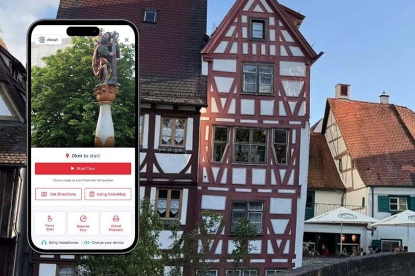 A smartphone displaying a tour app interface with a medieval building in the background. 1