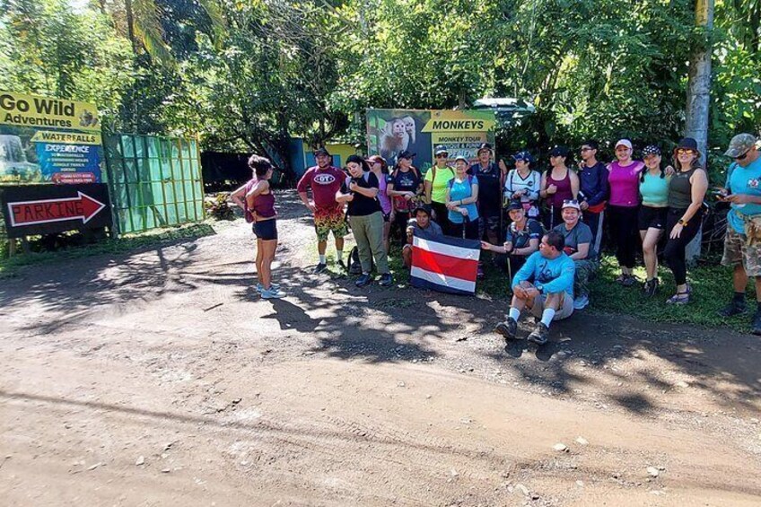 A group of people at a park entrance with signs for 'Go Wild Adventures' and 'Monkey's'. 3