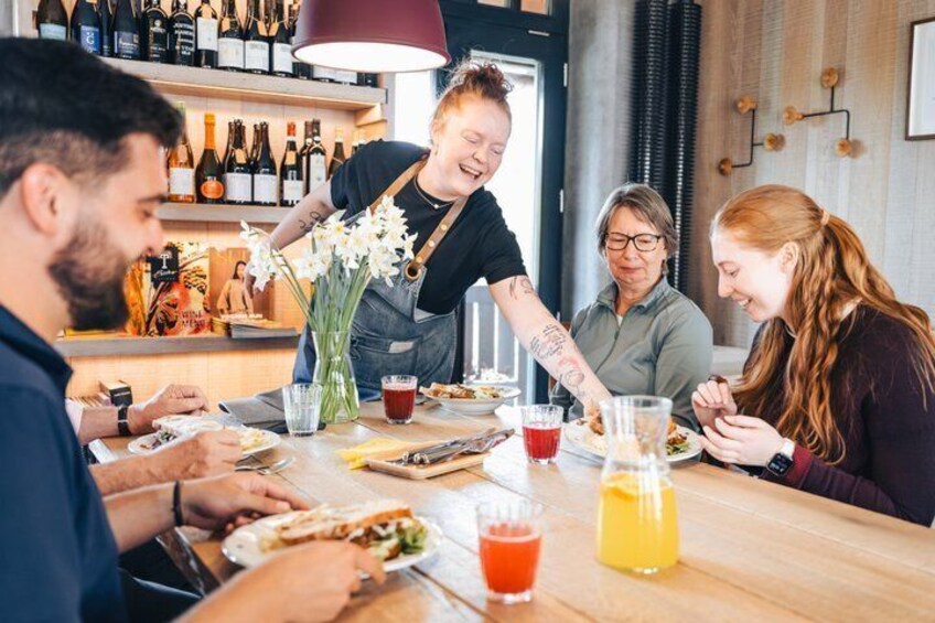 A group of people dining at a restaurant with a bar in the background. 3