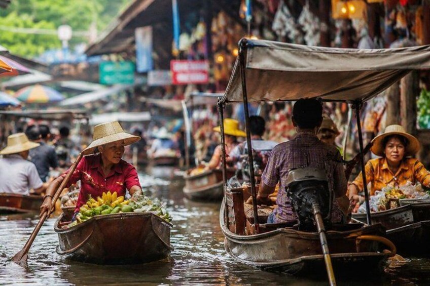 People in boats on a river, surrounded by market stalls and shops. 2