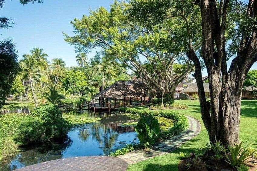 A serene pond, lush greenery, a gazebo, and a pathway. 4