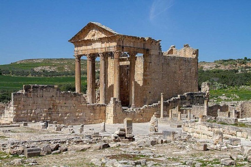 Ancient ruins with columns and a temple-like structure. 4