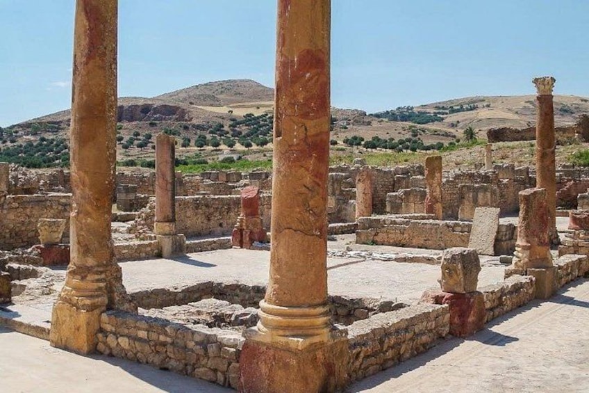 Ancient ruins with columns and stone structures. 5