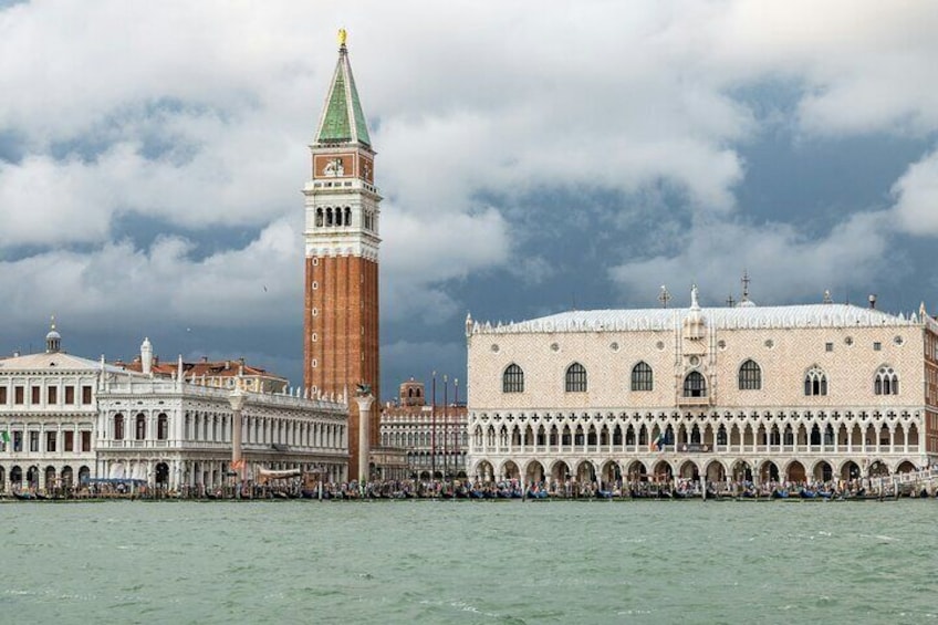 The Doge's Palace in Venice, Italy, with the bell tower of St. Mark's Basilica in the background. 1