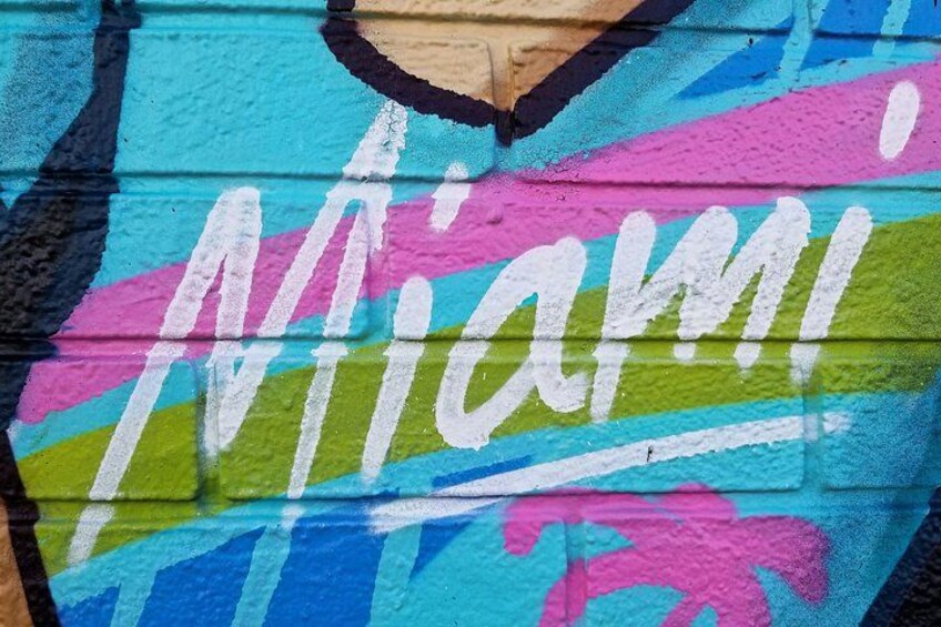 A colorful mural with the word 'Miami' painted on a wall. 1
